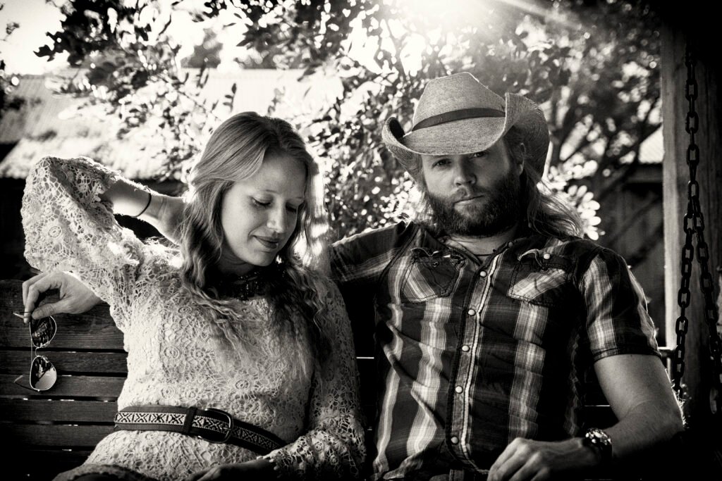 Simon and Rebecca sitting on swing bench in Gruene Texas