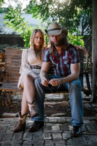 Simon and Rebecca sitting on swing bench in Gruene Texas